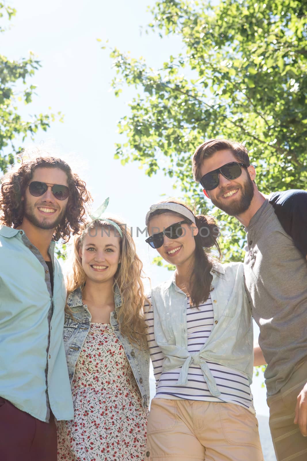 Happy friends smiling at camera by Wavebreakmedia