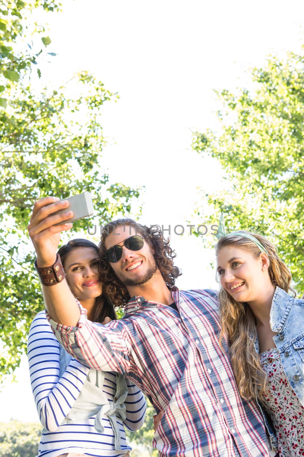 Happy friends taking a selfie on a summers day
