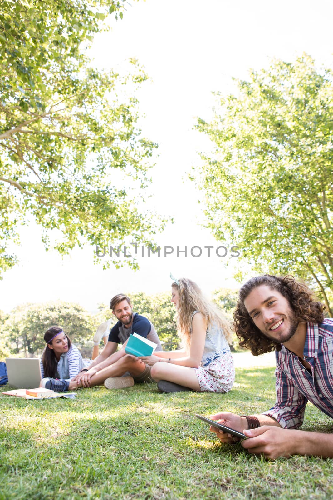 Classmates revising together on campus on a summers day