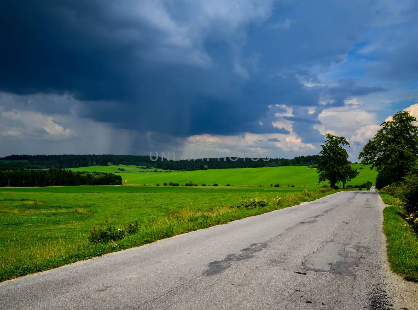 landscape with road and in the distance rains