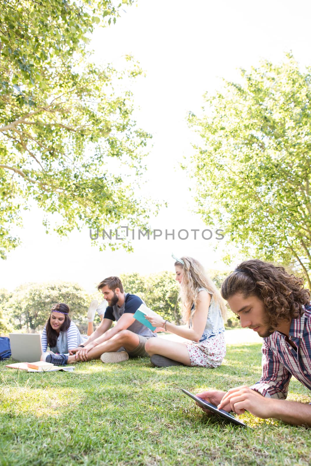 Classmates revising together on campus on a summers day