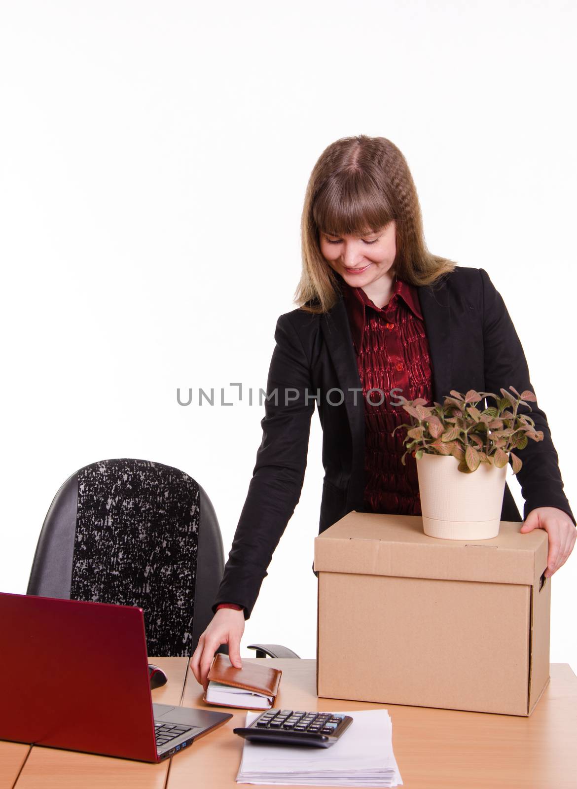The girl accepted a job at the office and arranges personal belongings at the new workplace