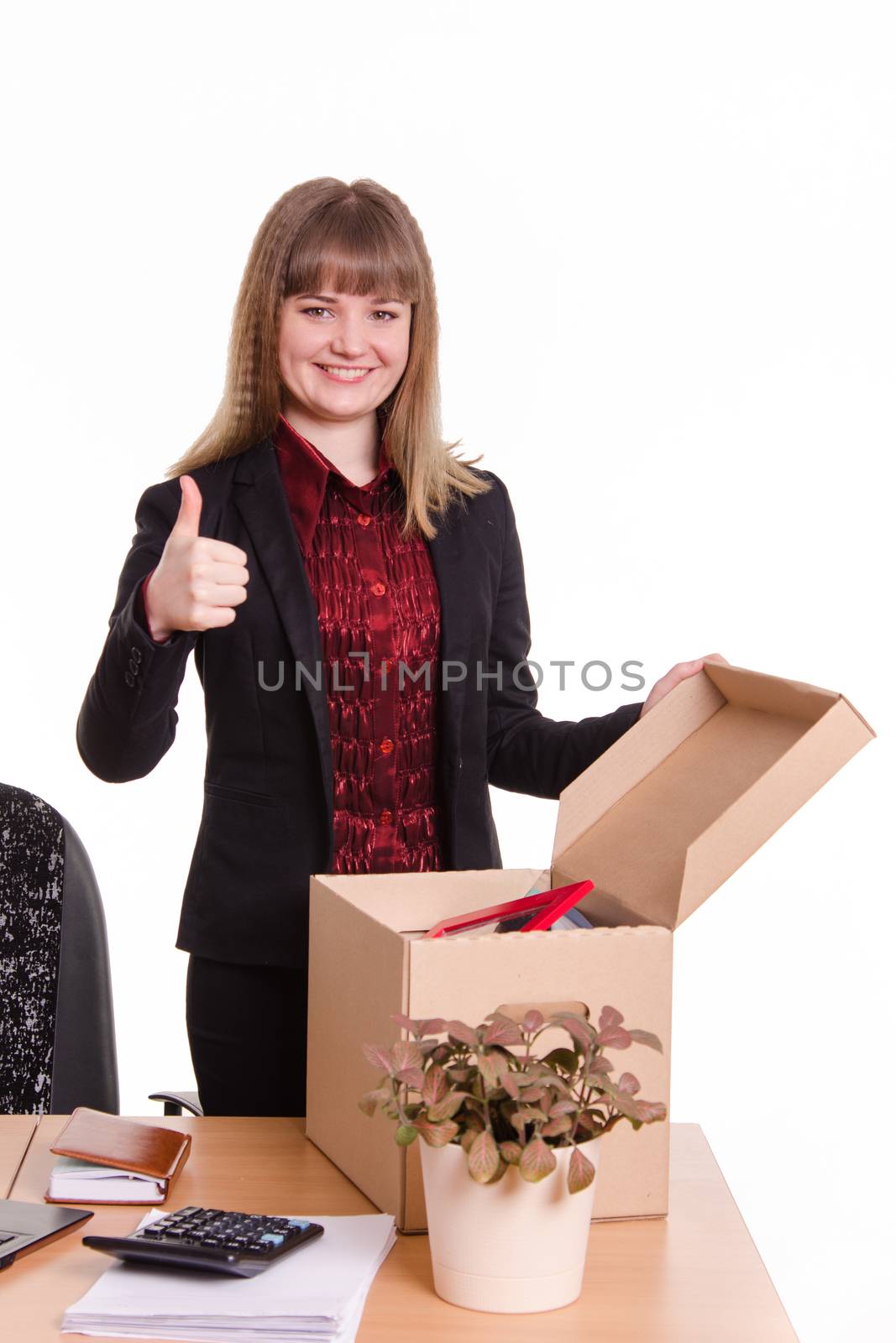 The girl accepted a job at the office and arranges personal belongings at the new workplace