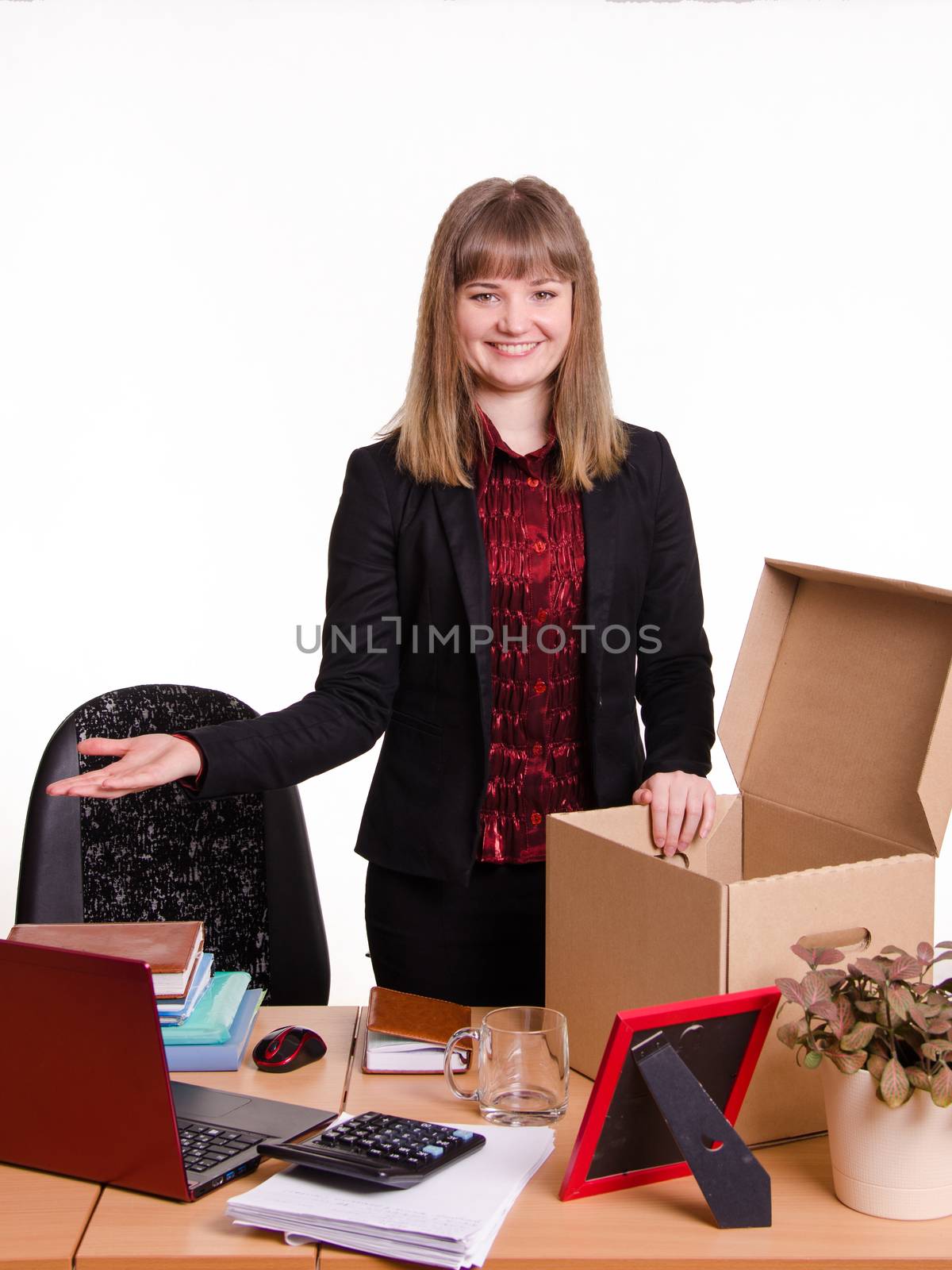 The girl accepted a job at the office and arranges personal belongings at the new workplace