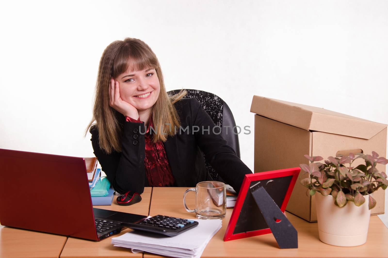 Cute business woman in the office at the computer