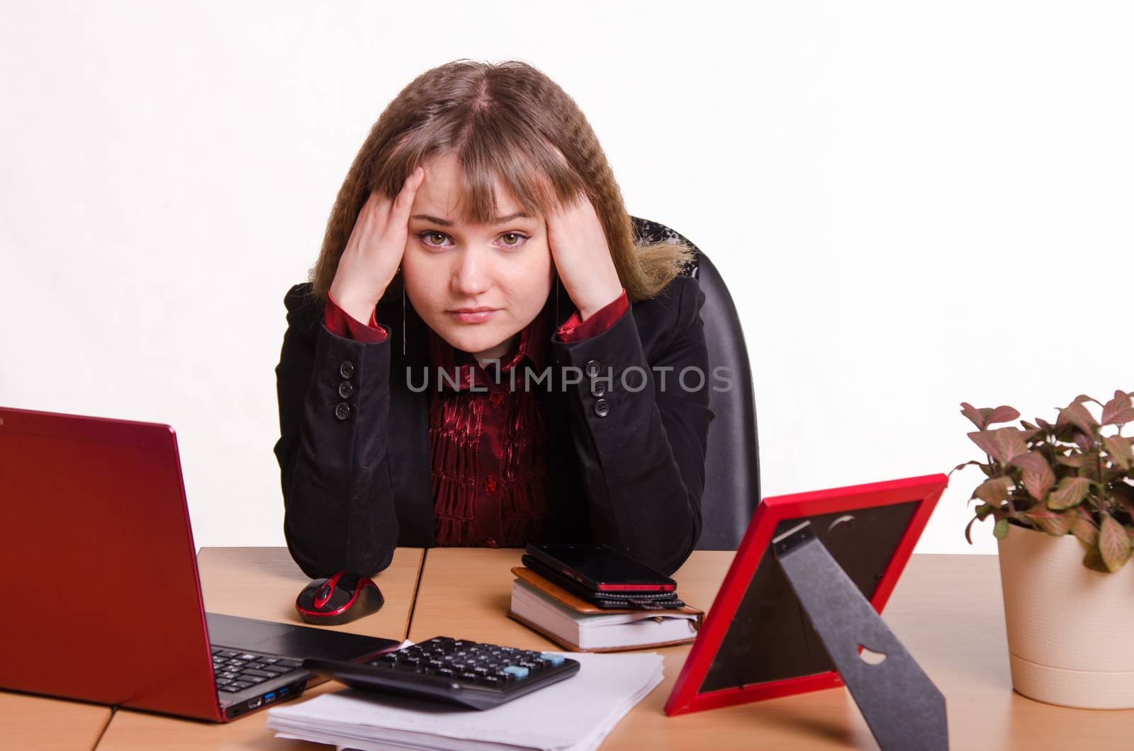 Cute business woman in the office at the computer