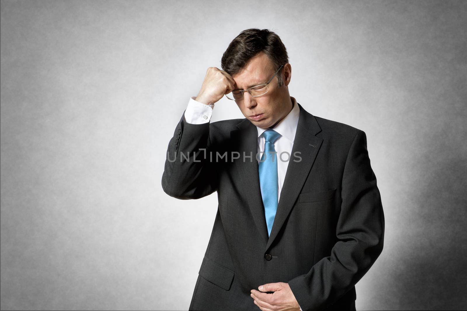 Image of a thinking and concentrated business man in dark suit