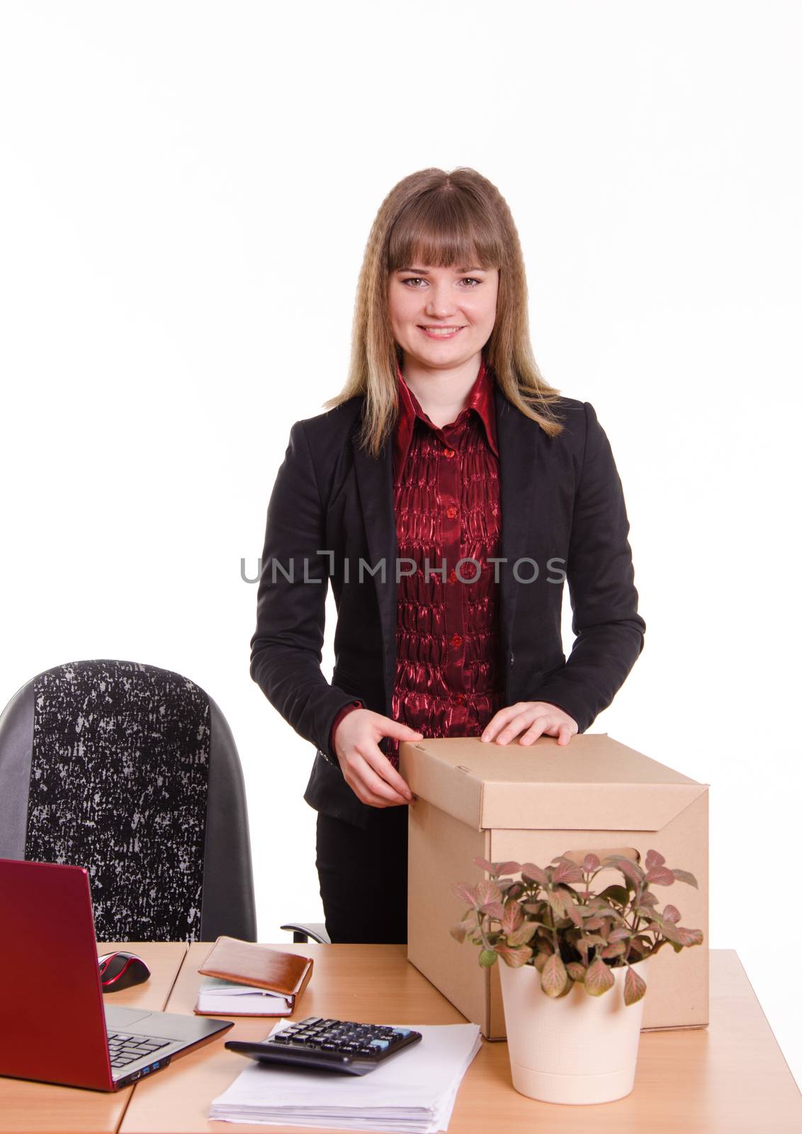 The girl accepted a job at the office and arranges personal belongings at the new workplace