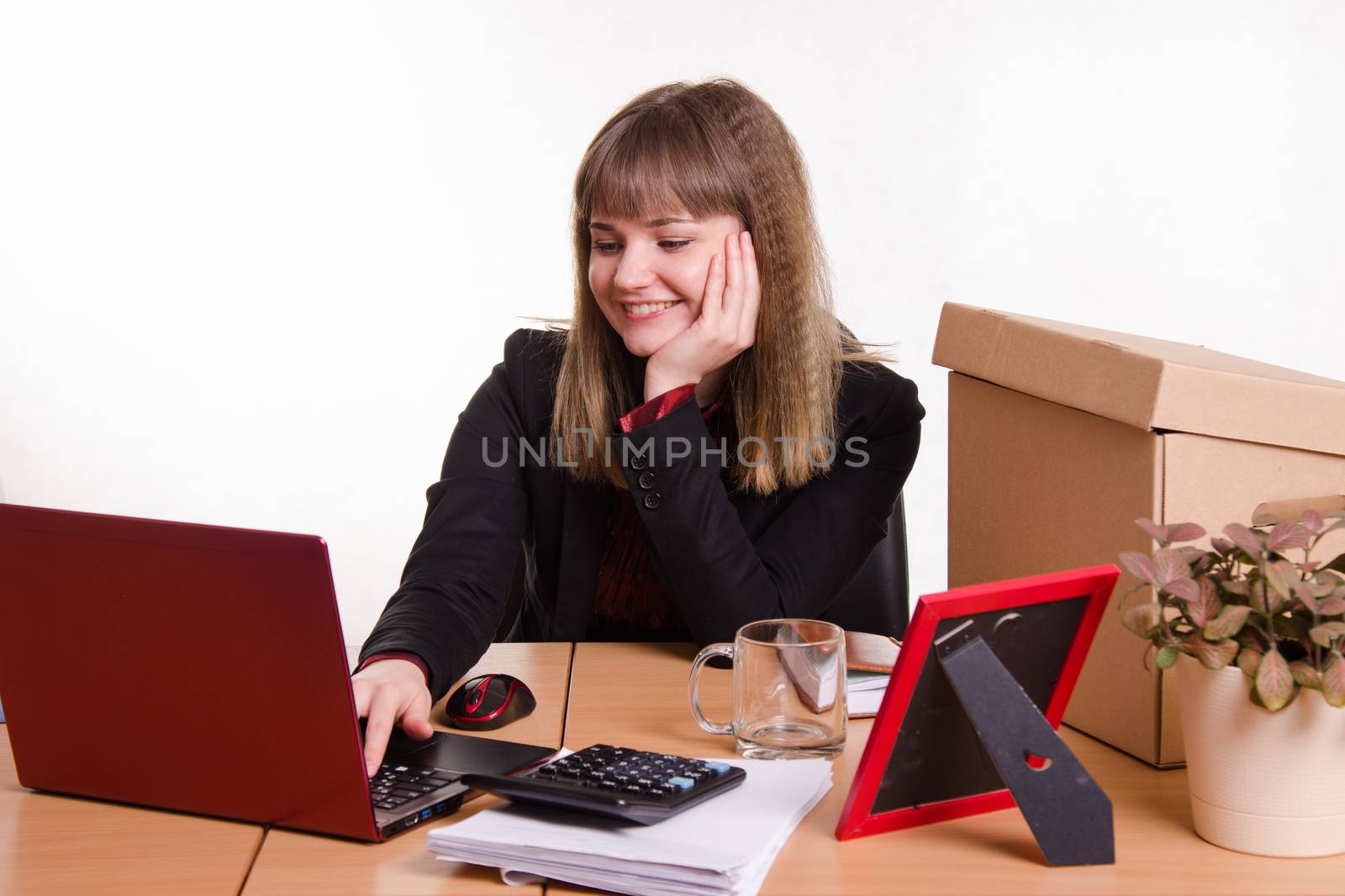 Cute business woman in the office at the computer
