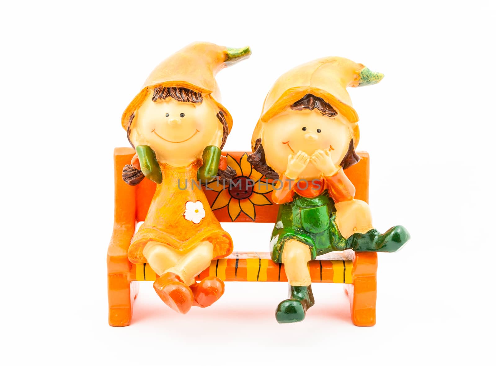 Boy and Girl Dolls sitting on Bench.