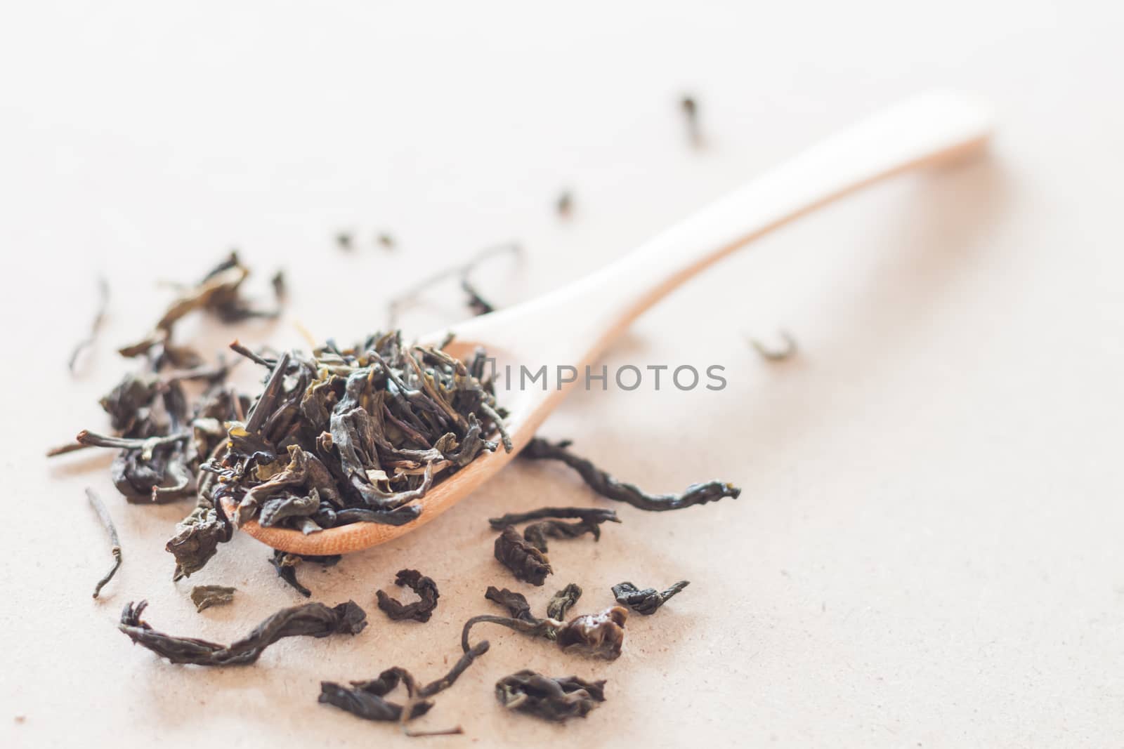 Dry tea in wooden spoon, stock photo