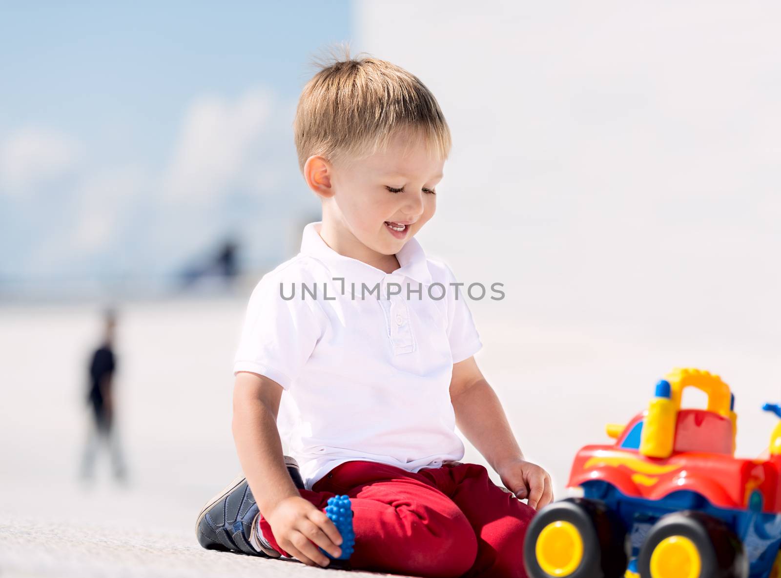 Little boy playing with toy car horizontal by Nanisimova