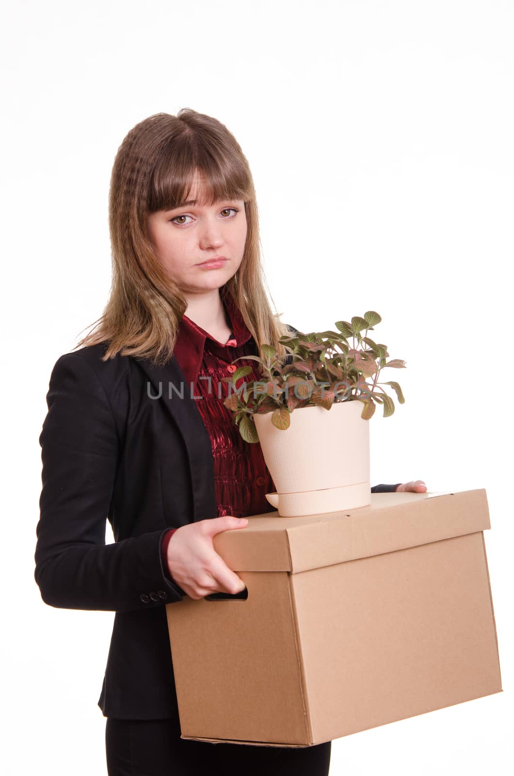 Sad girl fired from her job and holding a box with things