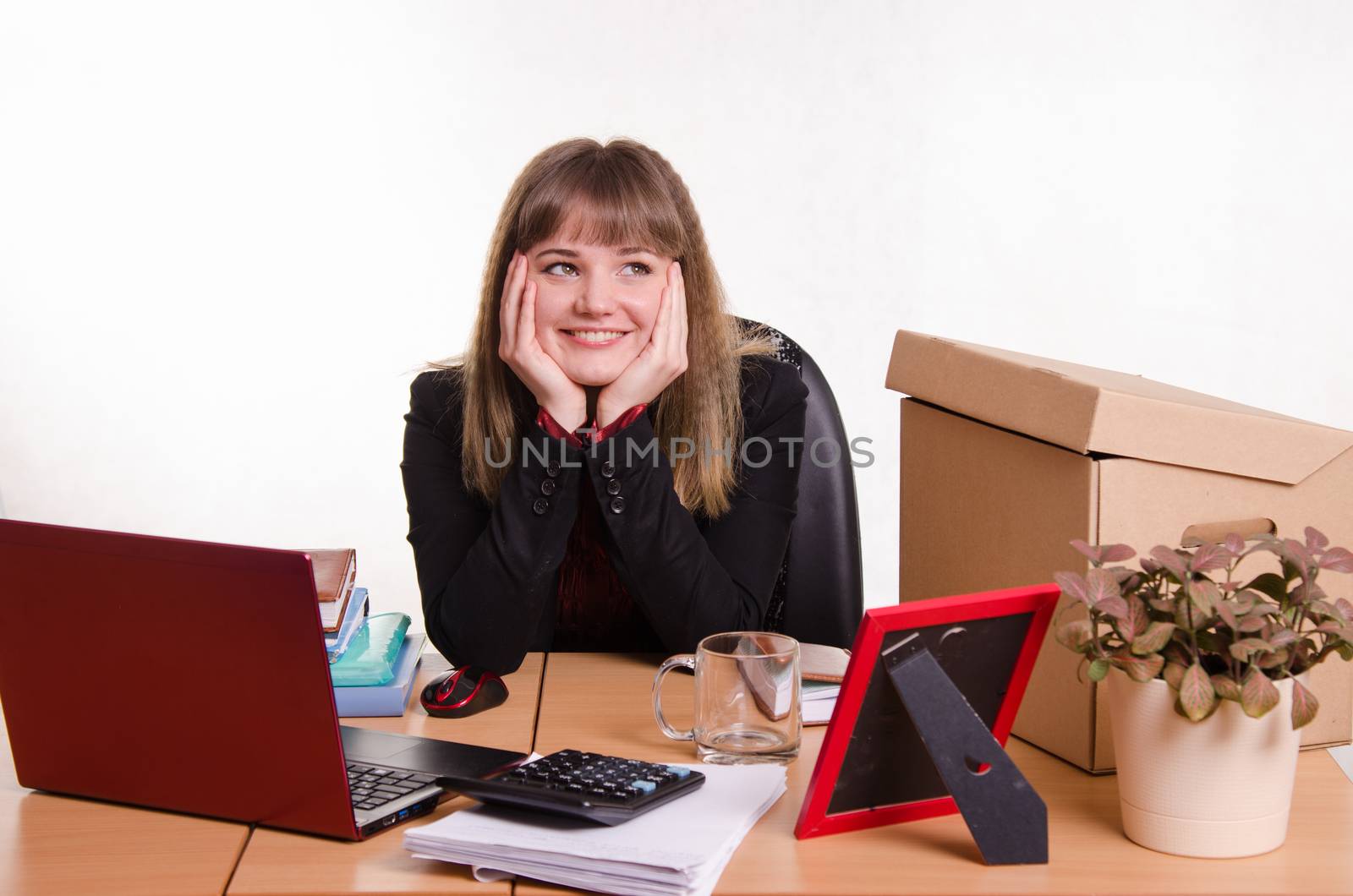 Cute business woman in the office at the computer