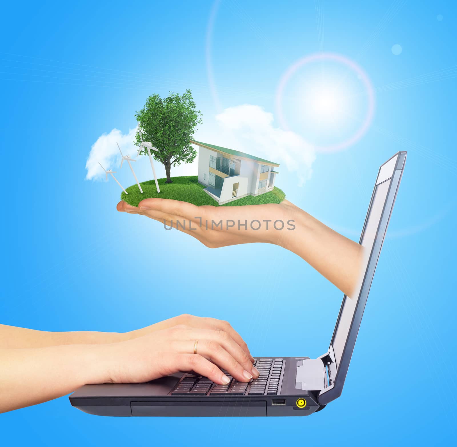 White house in hand with green roof of screen laptop. Background sun shines brightly on right by cherezoff