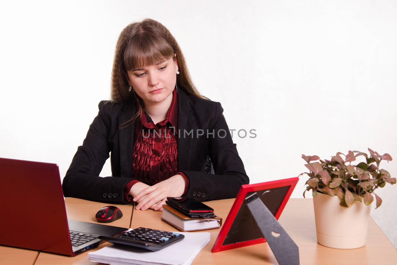 Cute business woman in the office at the computer