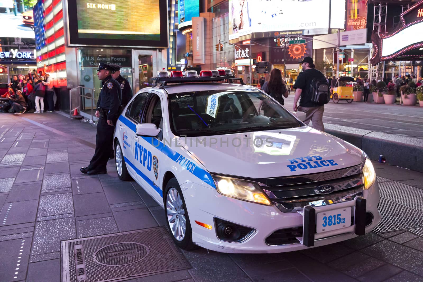 New York City, USA - OCT 9, 2014 : Police car and policemen in the Times Square. Times Square is major commercial intersection in New York and one of the most visited and protected tourist attractions in the world.