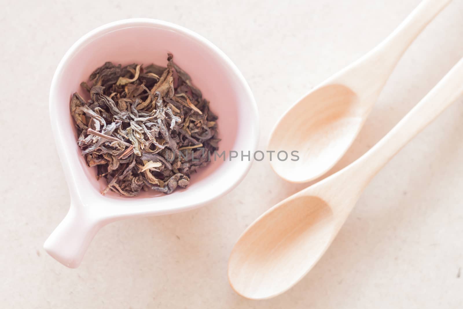 Oolong tea in ceramic cup and empty wooden spoons, stock photo