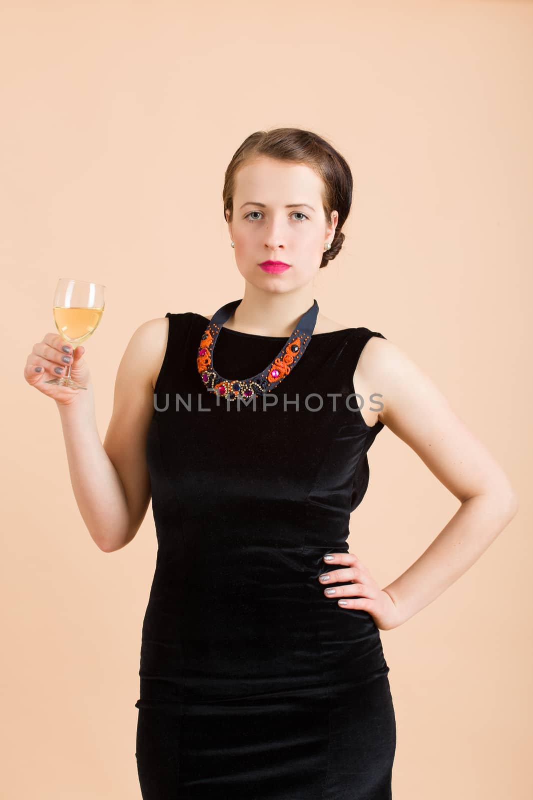 beautiful young brunette woman holding a glass of white wine by artush