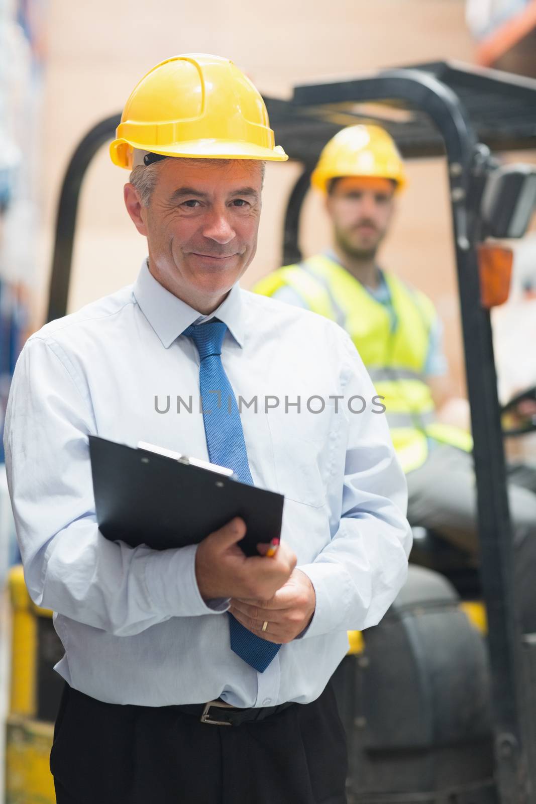 Manager standing in front of his employee in warehouse