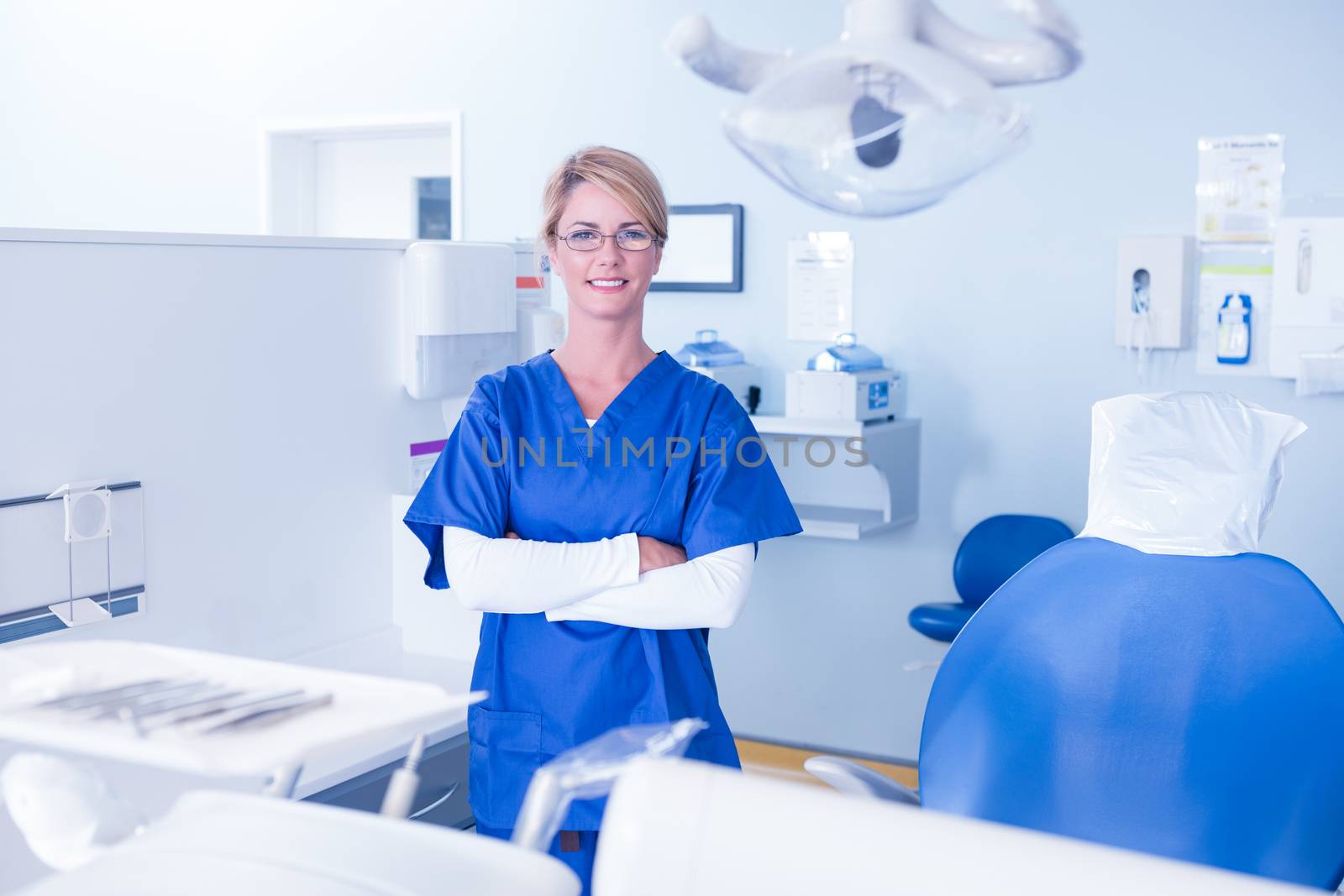 Dentist smiling at camera with arms crossed by Wavebreakmedia