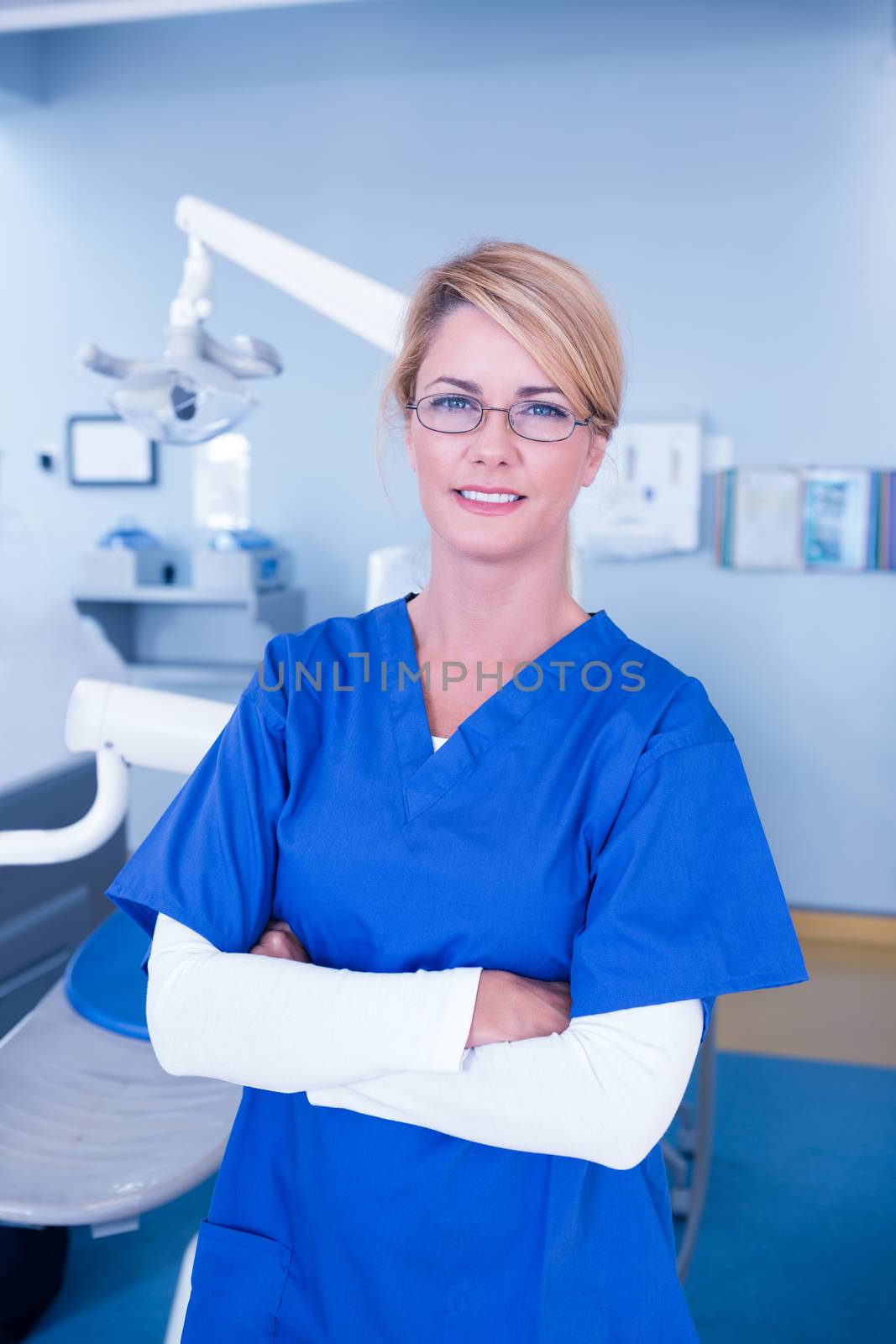 Dentist smiling at camera with arms crossed by Wavebreakmedia