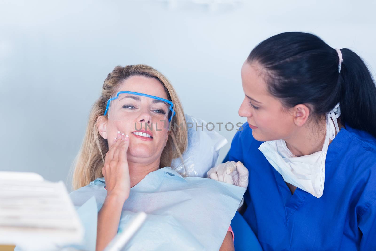 Dentist speaking with patient about toothache at the dental clinic