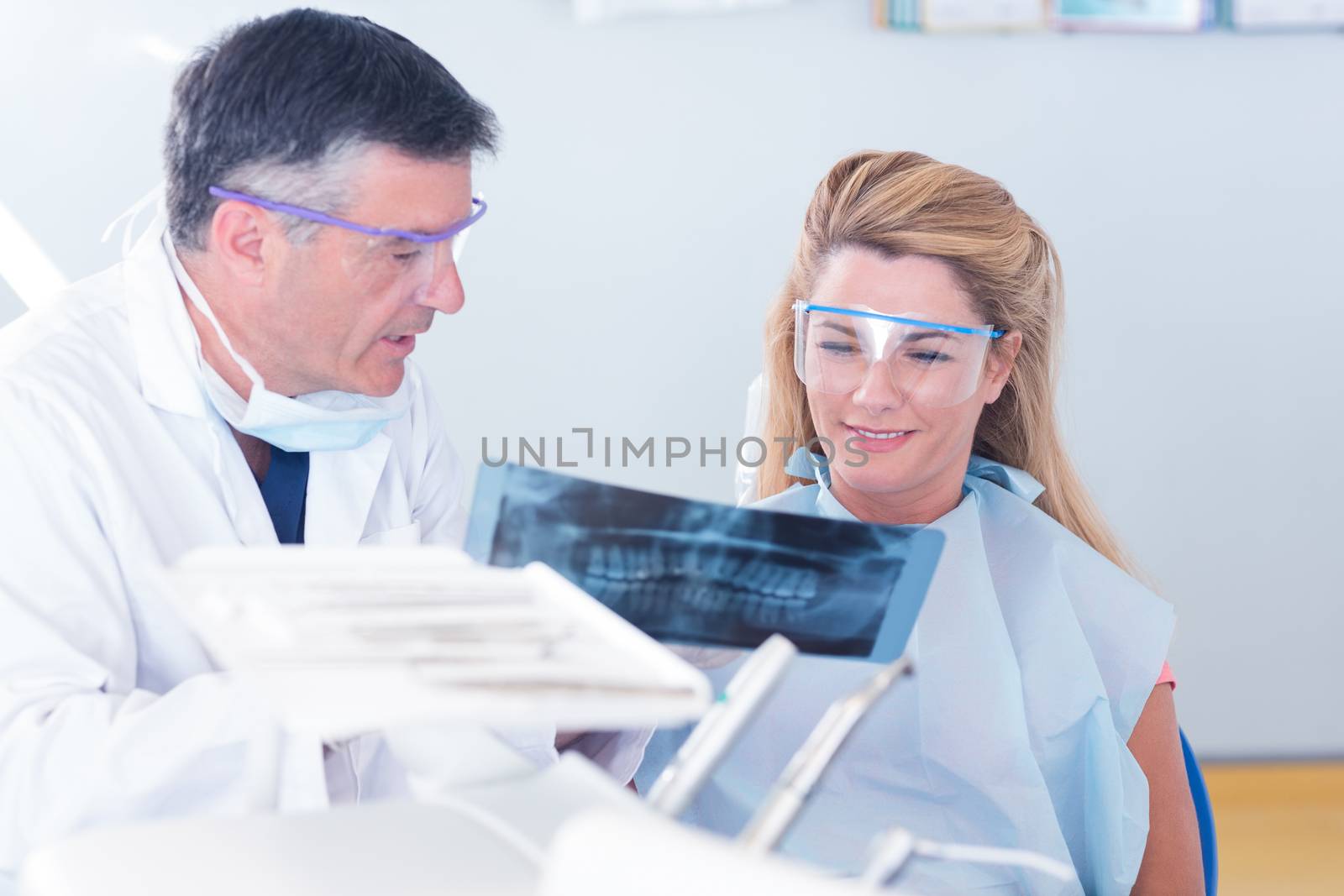 Dentist showing x-ray to his patient by Wavebreakmedia