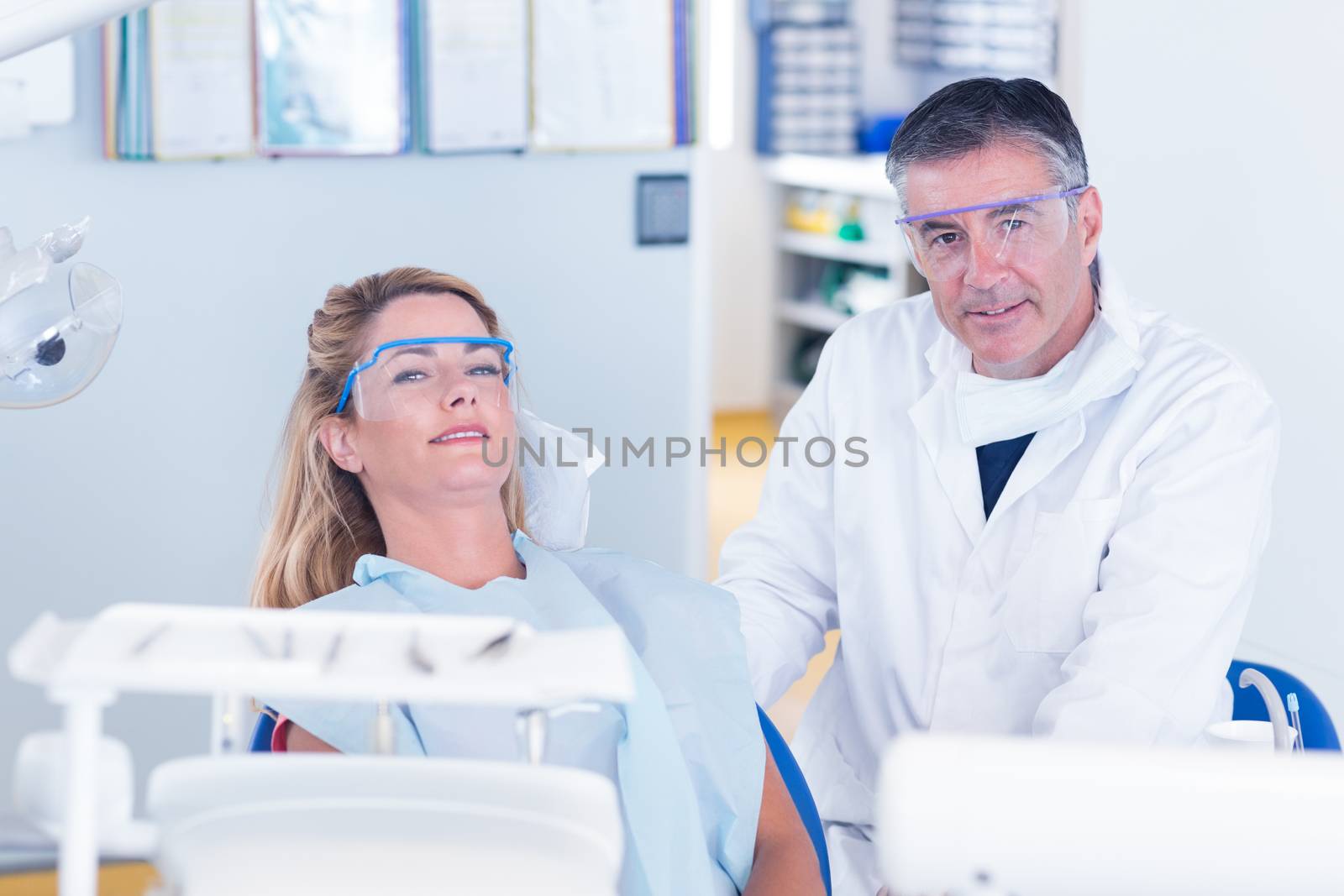 Patient and dentist smiling at camera by Wavebreakmedia