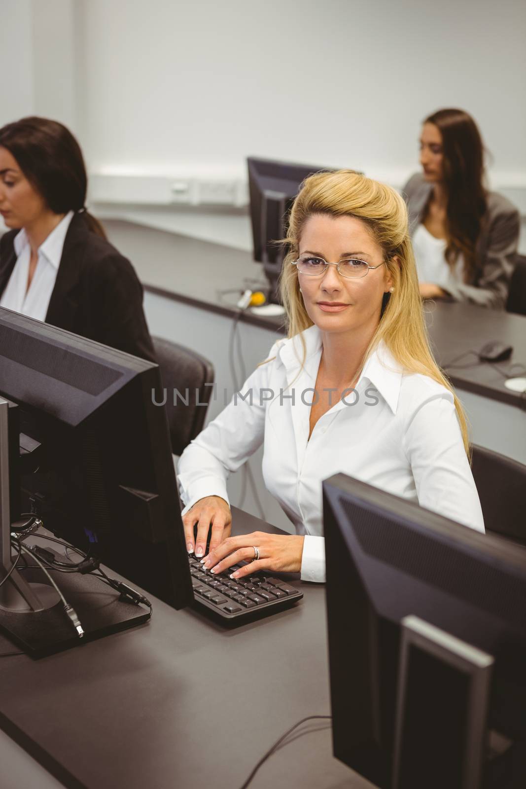 Smiling businesswoman working in computer room in the office