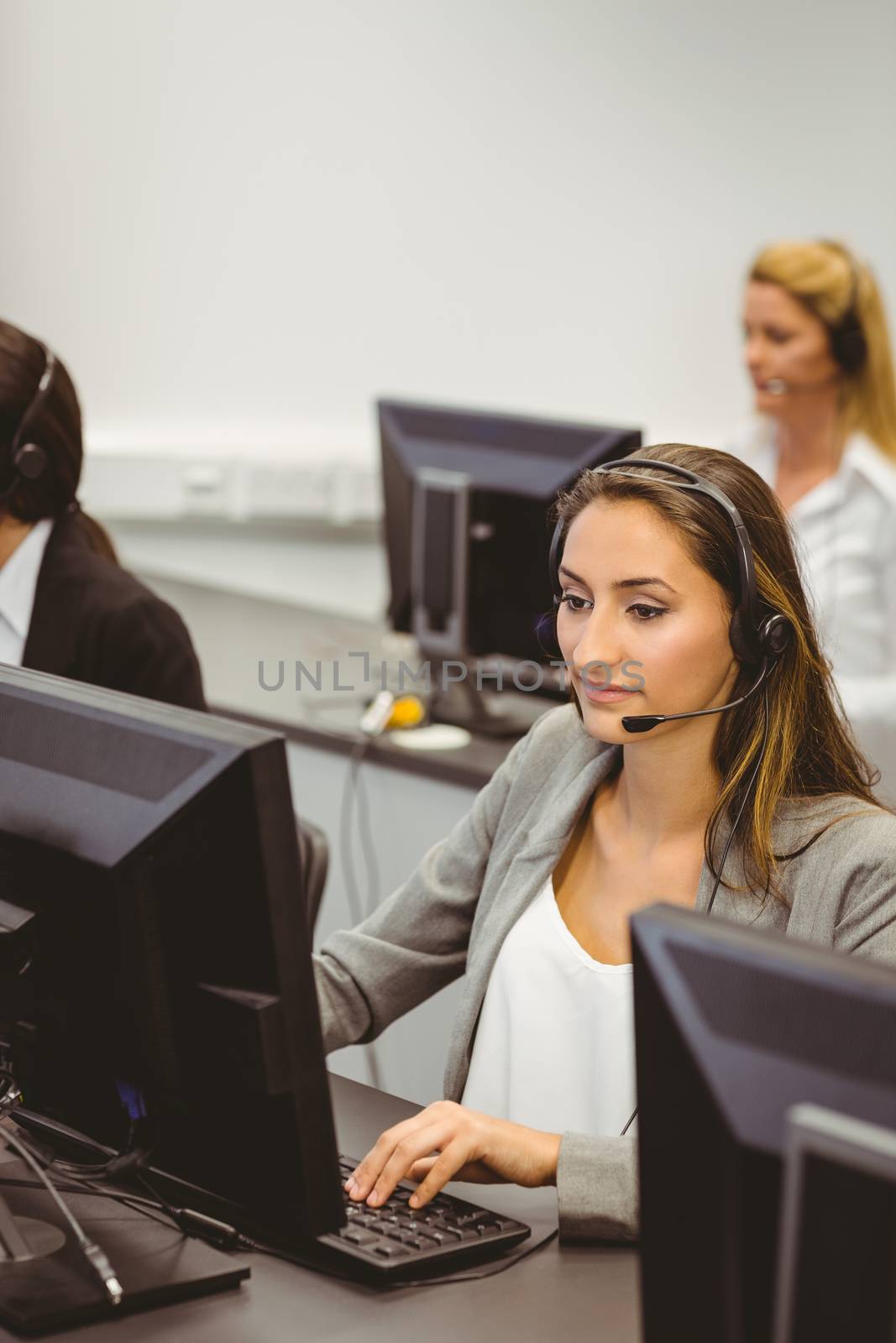 Call centre agents talking on the headset in the office