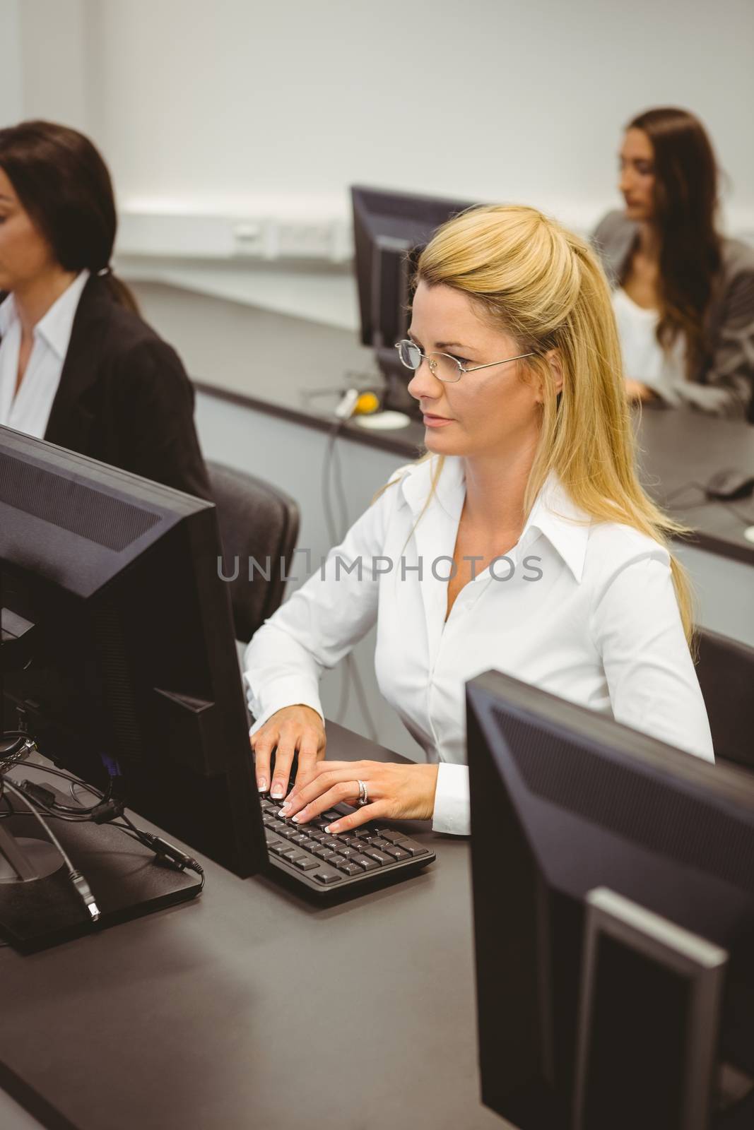 Focused businesswomen working in computer room in the office