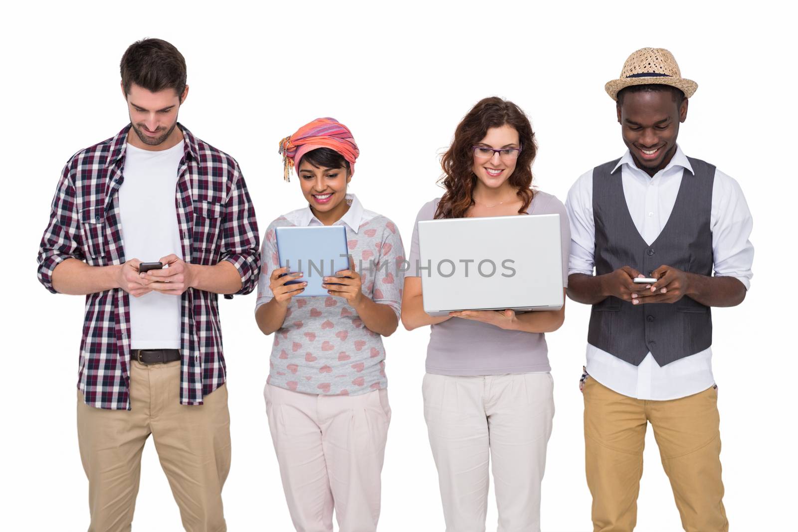 Smiling coworkers standing and using technology on white background