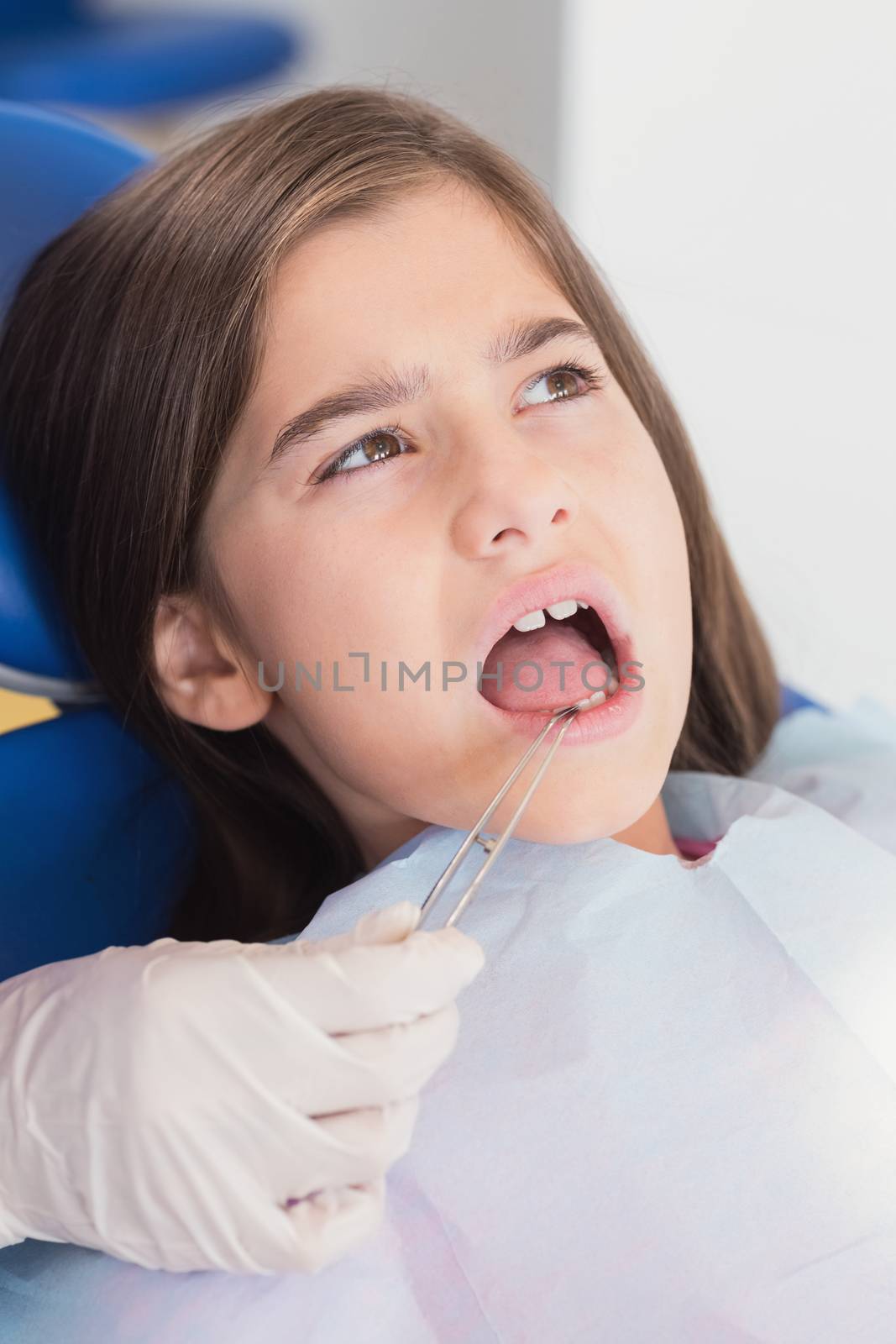 Portrait of a young patient in dental examination in clinic