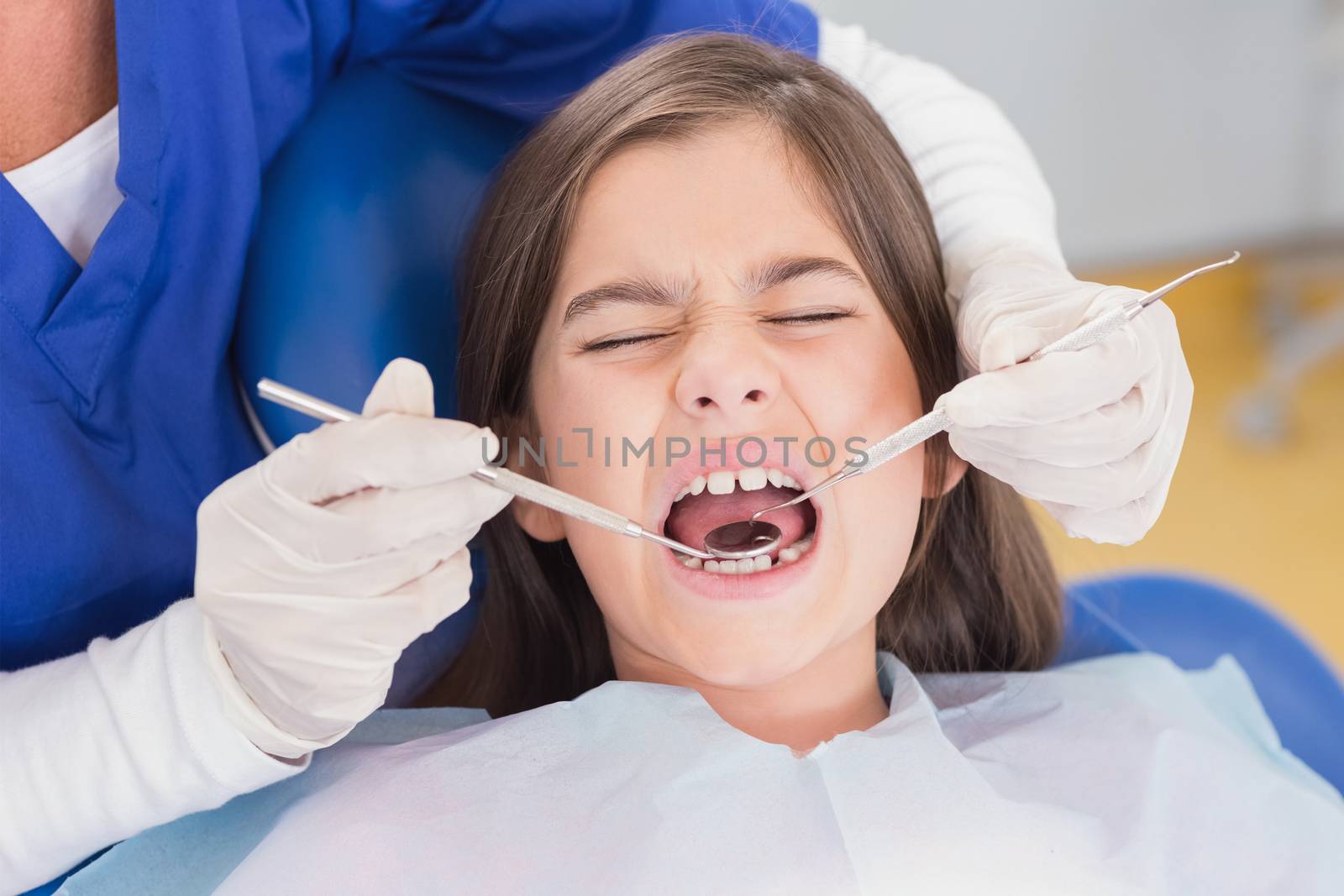 Portrait of a scared young patient in dental examination by Wavebreakmedia