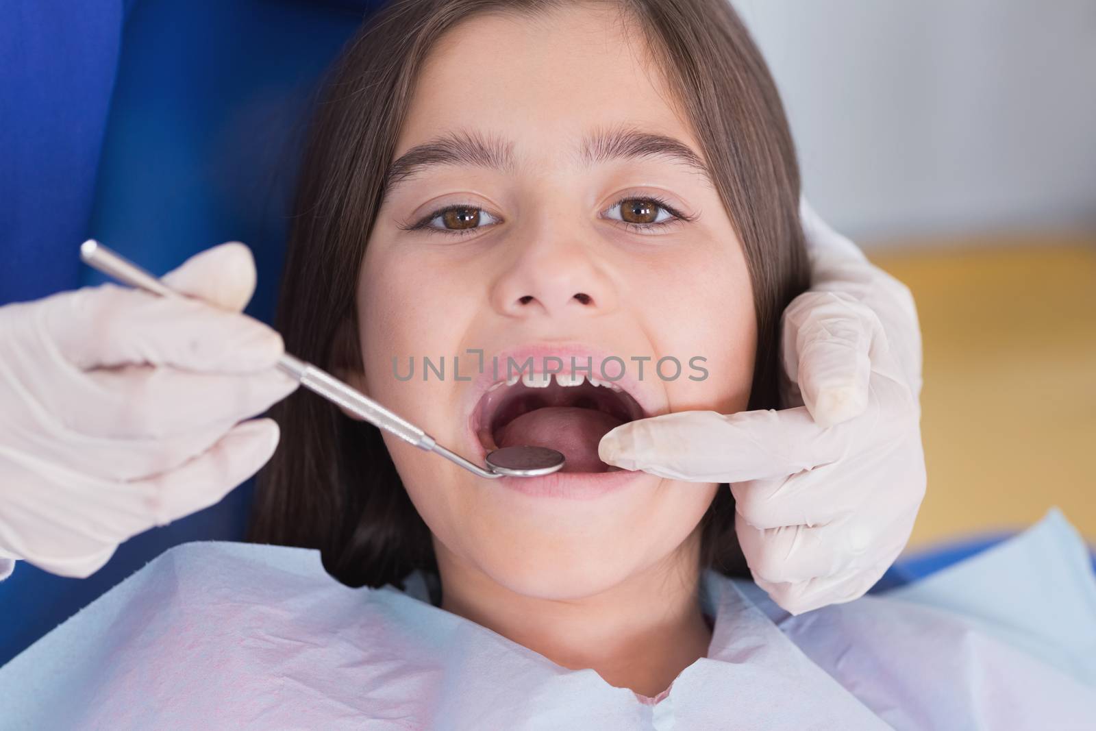 Portrait of a young patient in dental examination in clinic