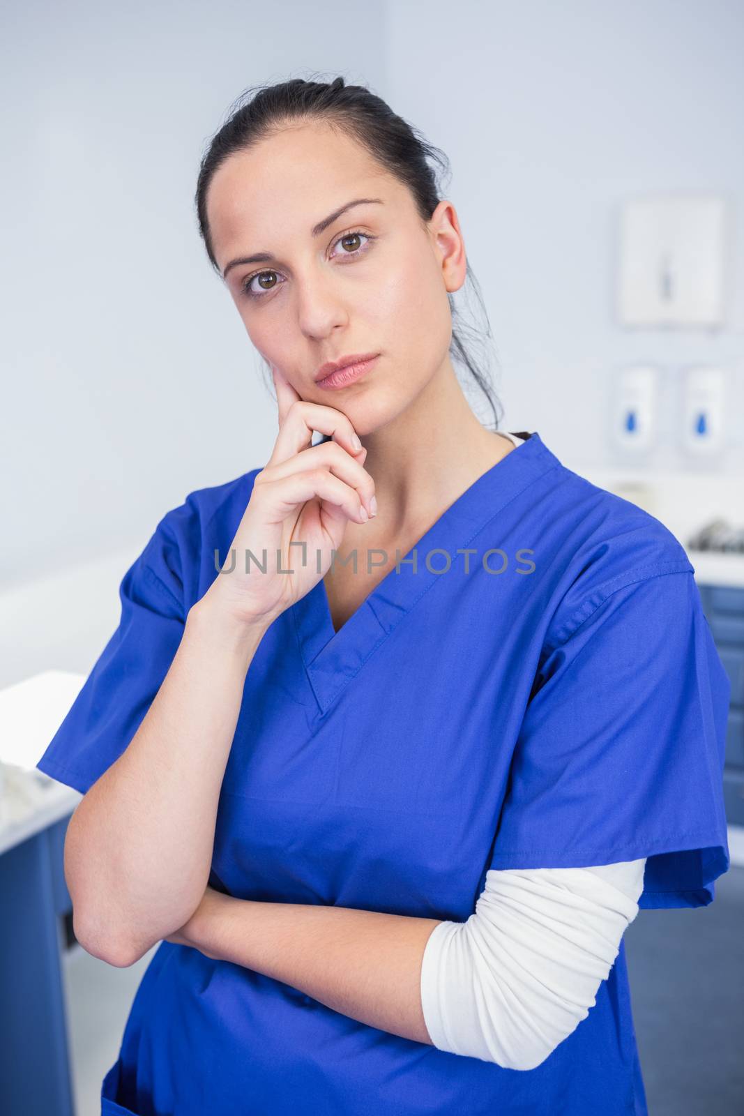 Portrait of a dentist thinking with arms crossed in dental clinic