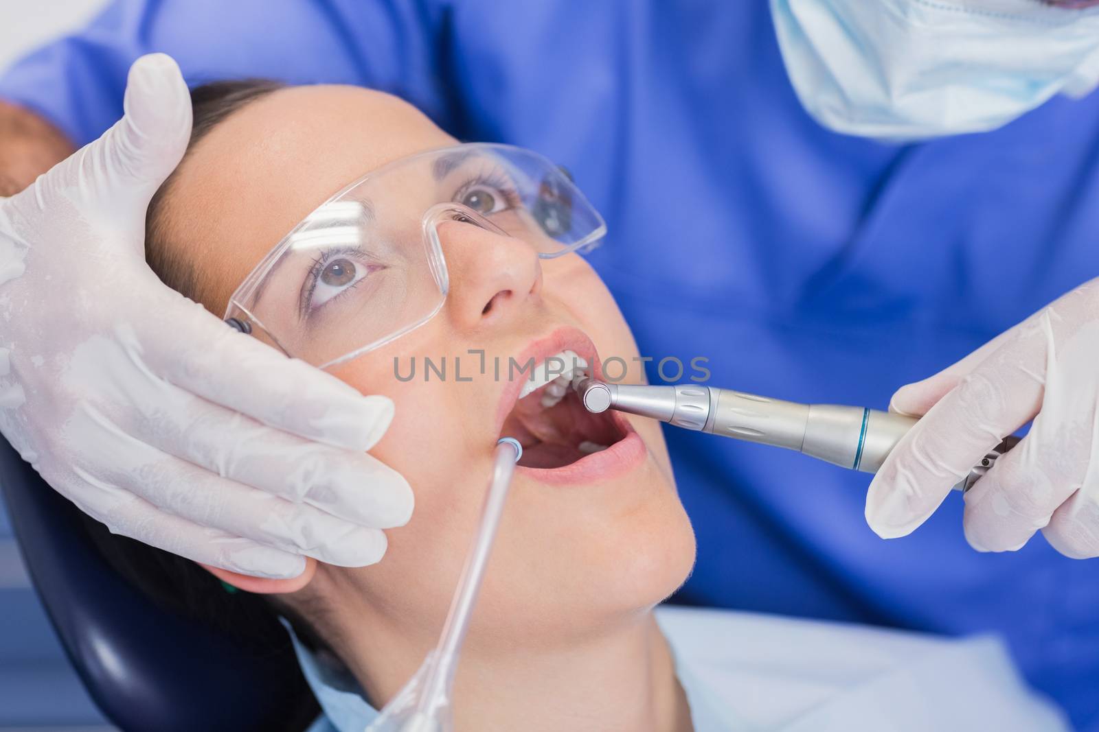 Dentist examining a patient with tools in dental clinic