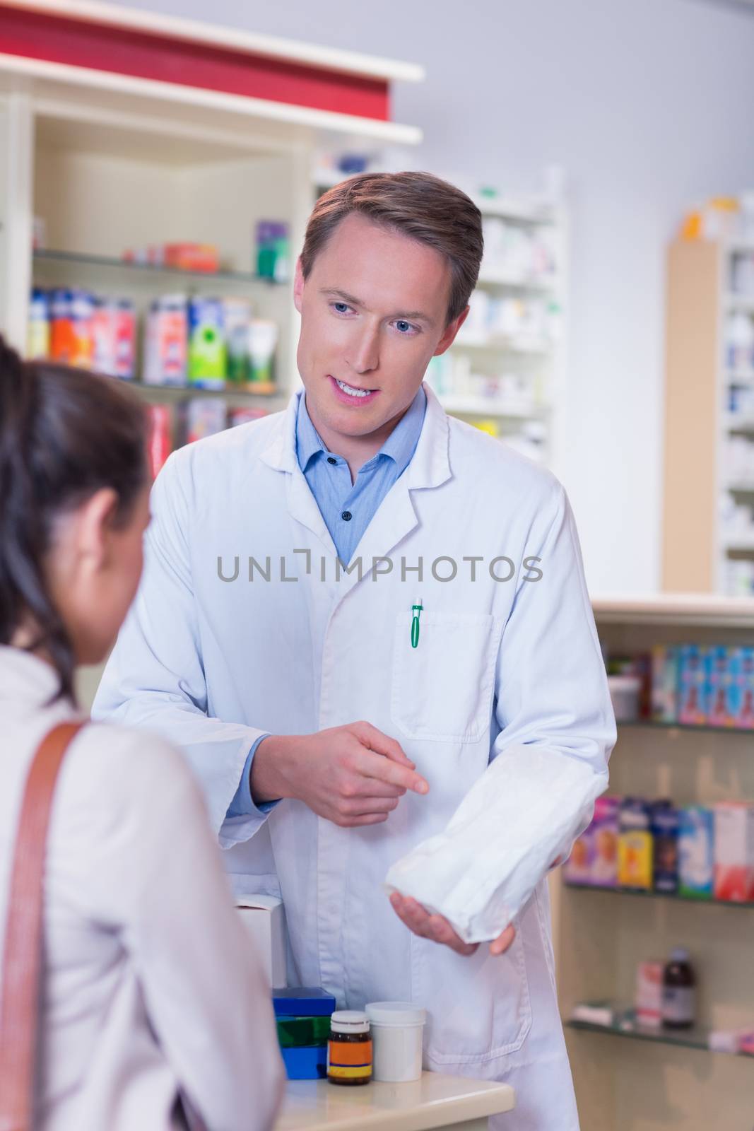 Pharmacist and sick customer speaking in the pharmacy