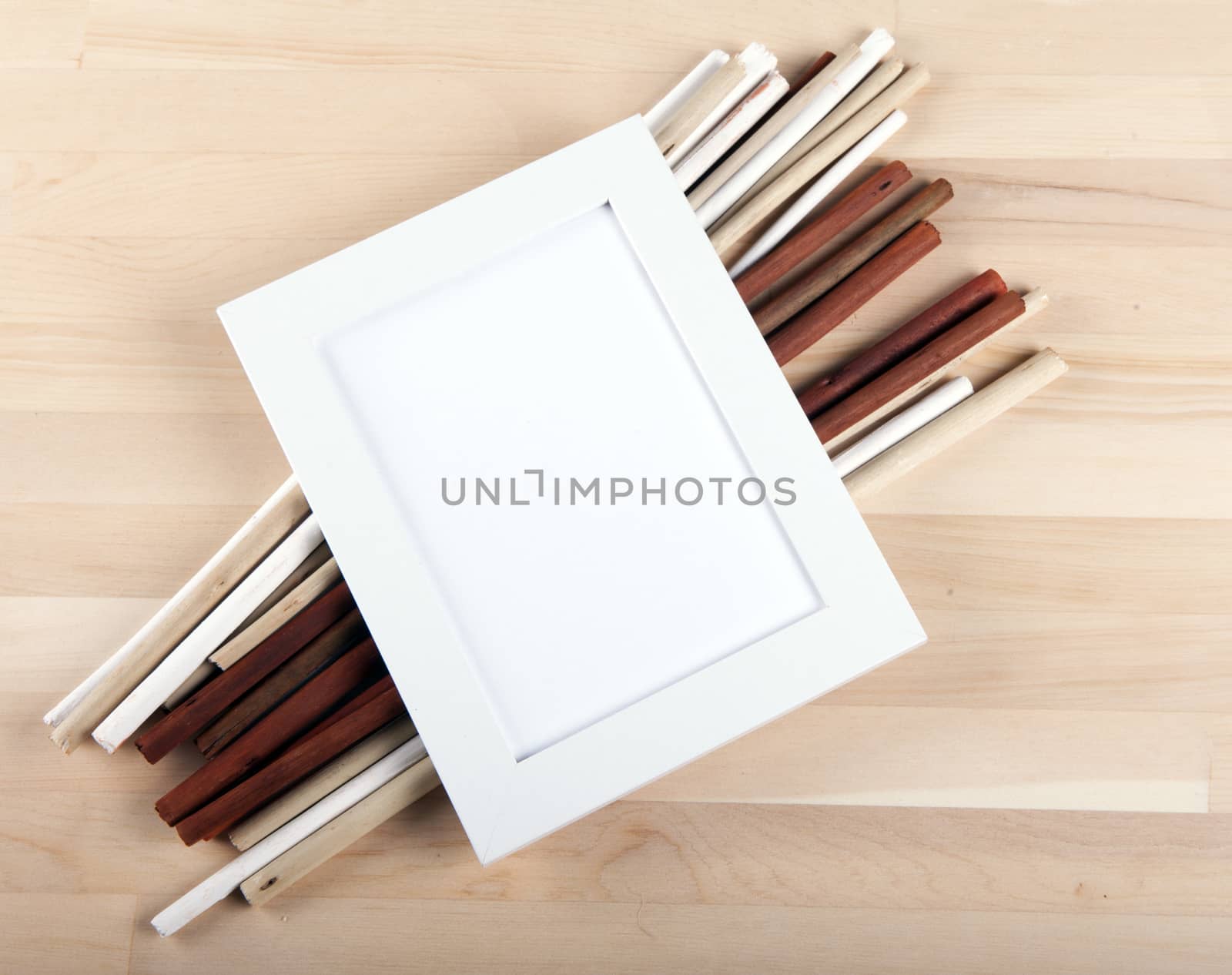 Beautiful composition with photo frames and wooden sticks.