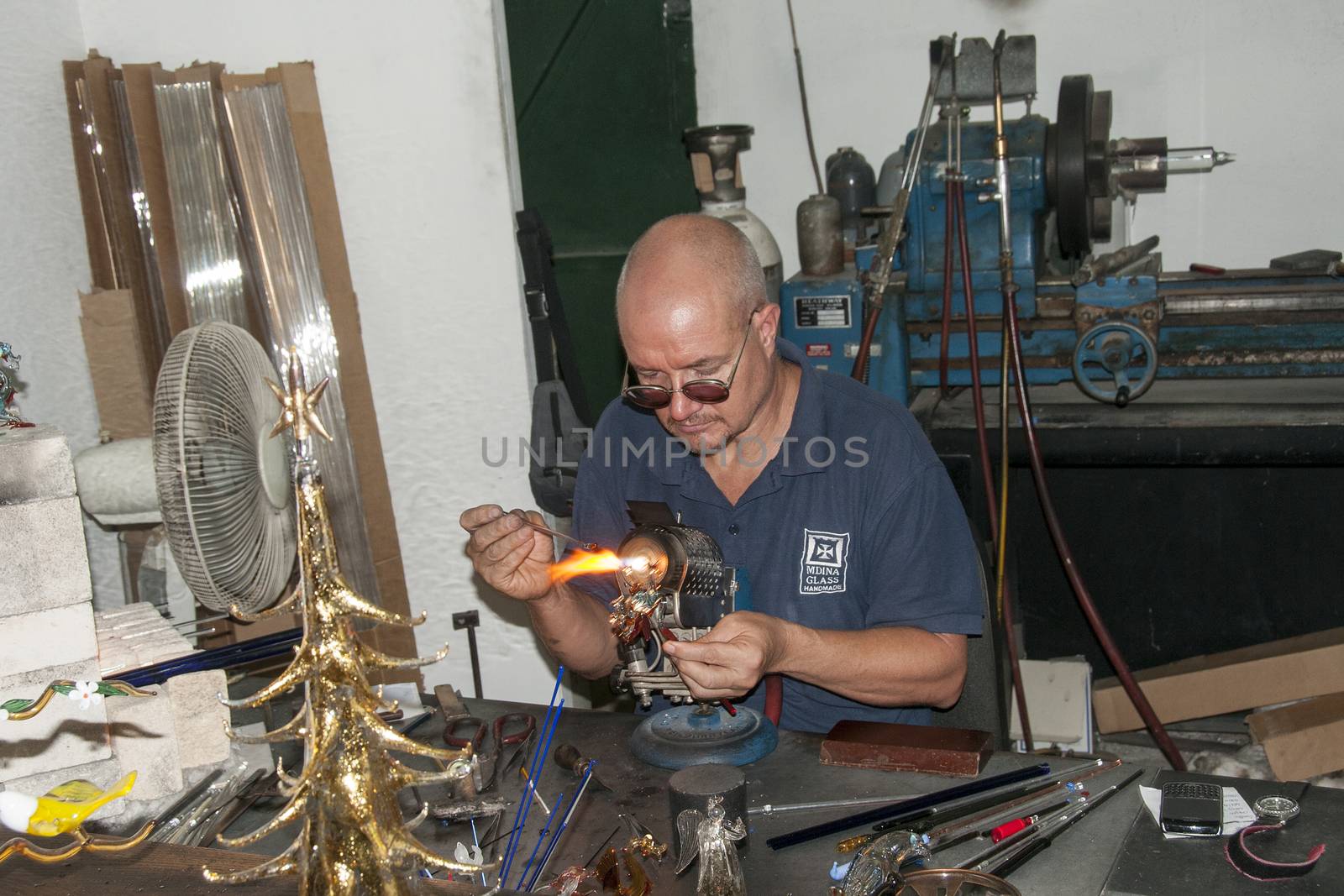 MDINA,MALTA-SEPTEMBER 29, 2011: Glass blower making glass in hot fire ,on September 29 2011, the glass blowers are showng their profession to tourist and sell the product when finished