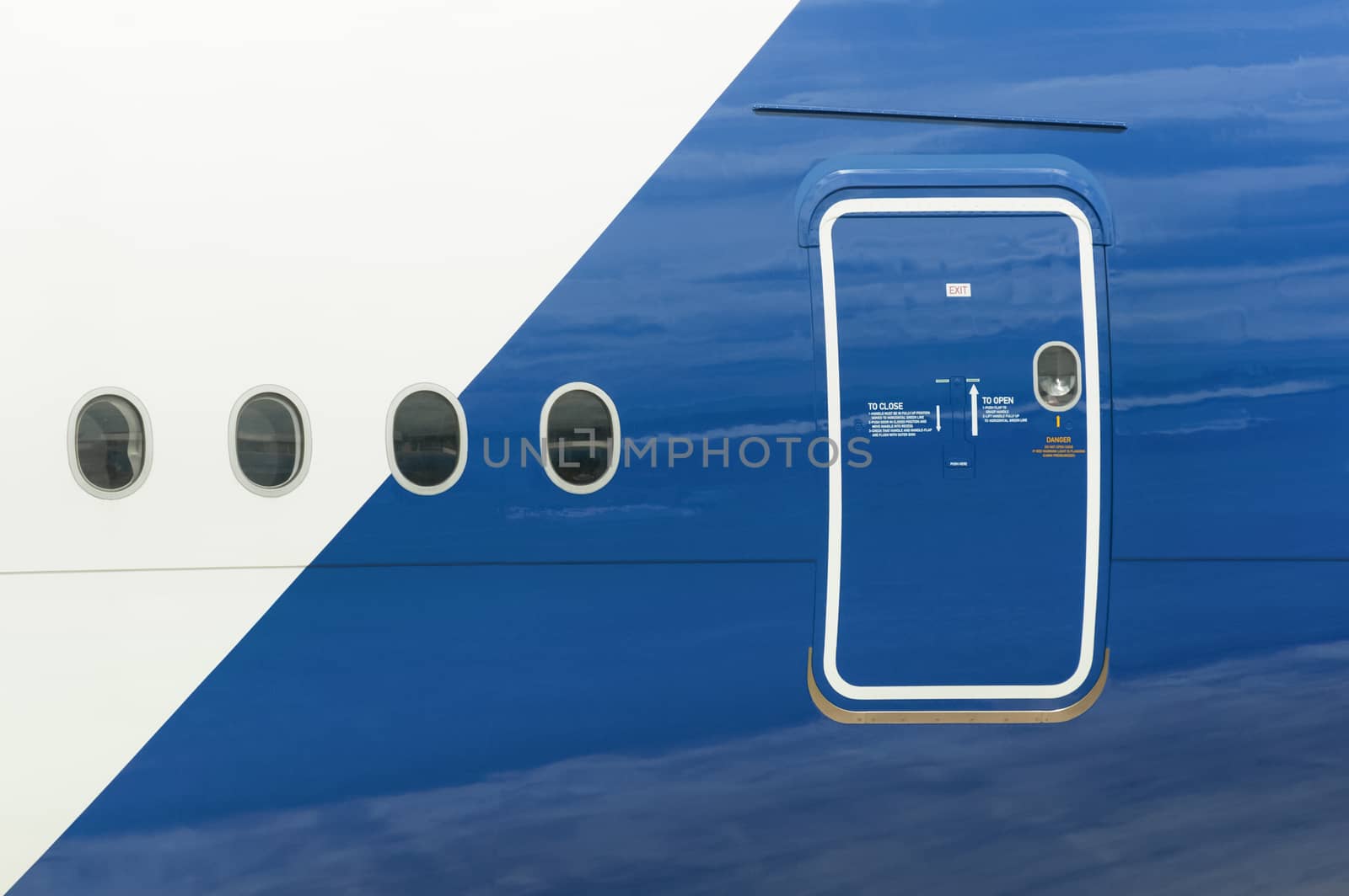 emergency exit and windows on the fuselage of a passenger aircraft