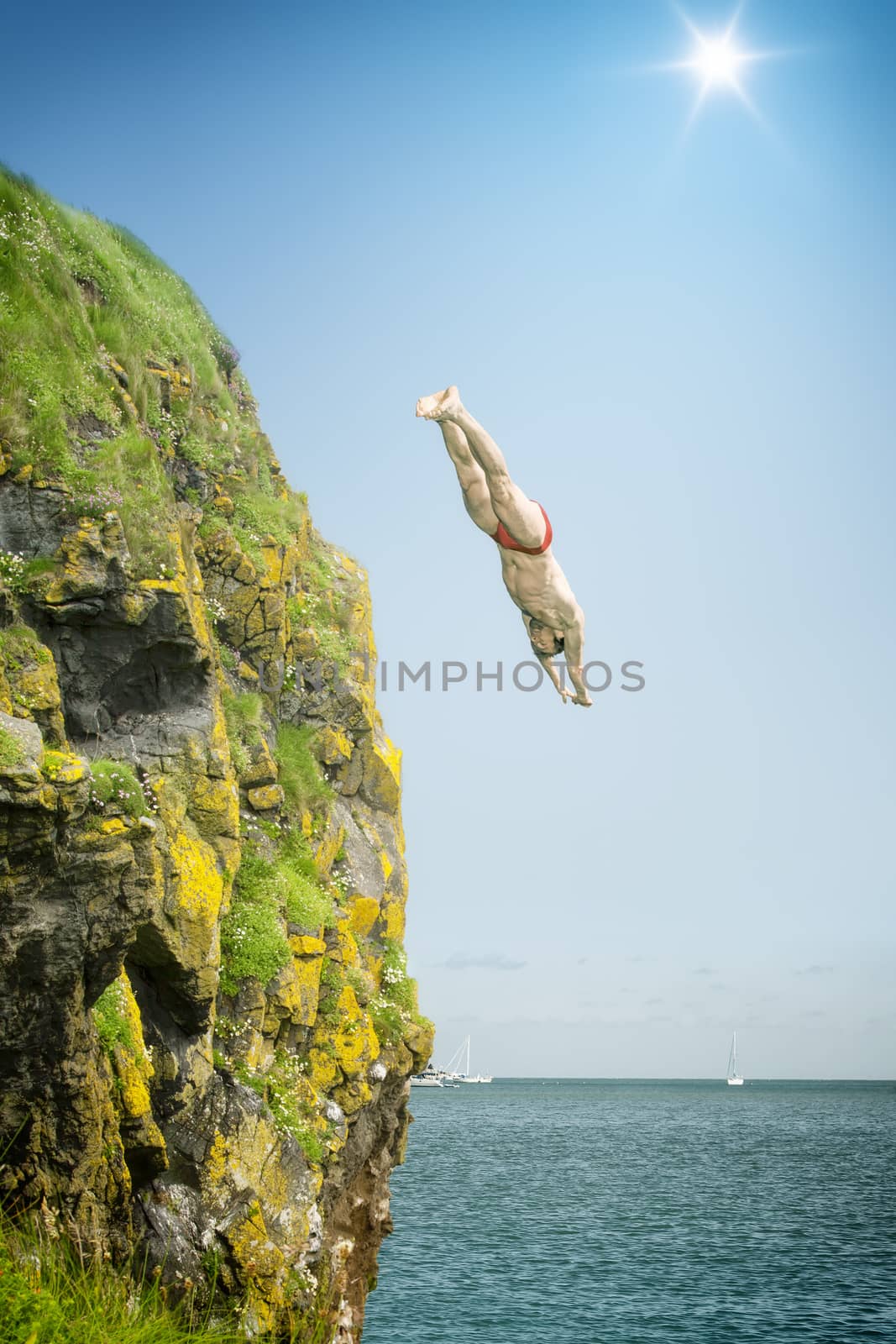 An image of a cliff jumper at the sea