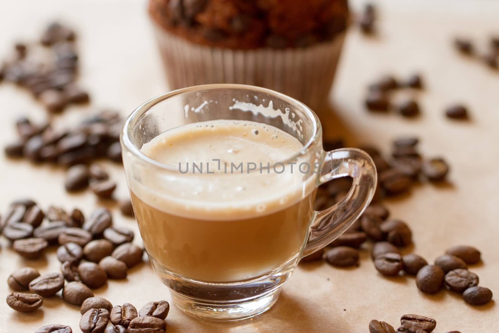 Cup of latte coffee with a biscotti