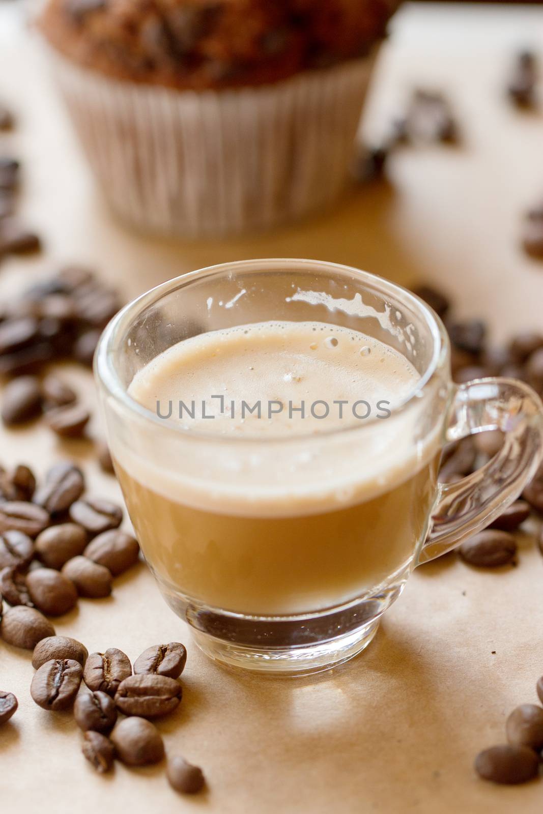Cup of latte coffee with a biscotti