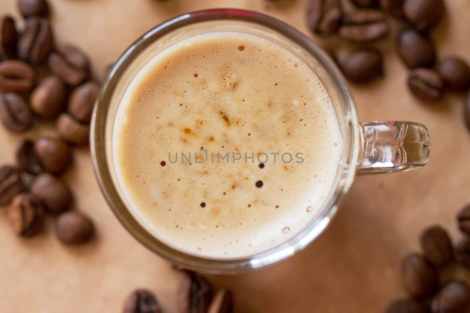 Cup of latte coffee with a biscotti