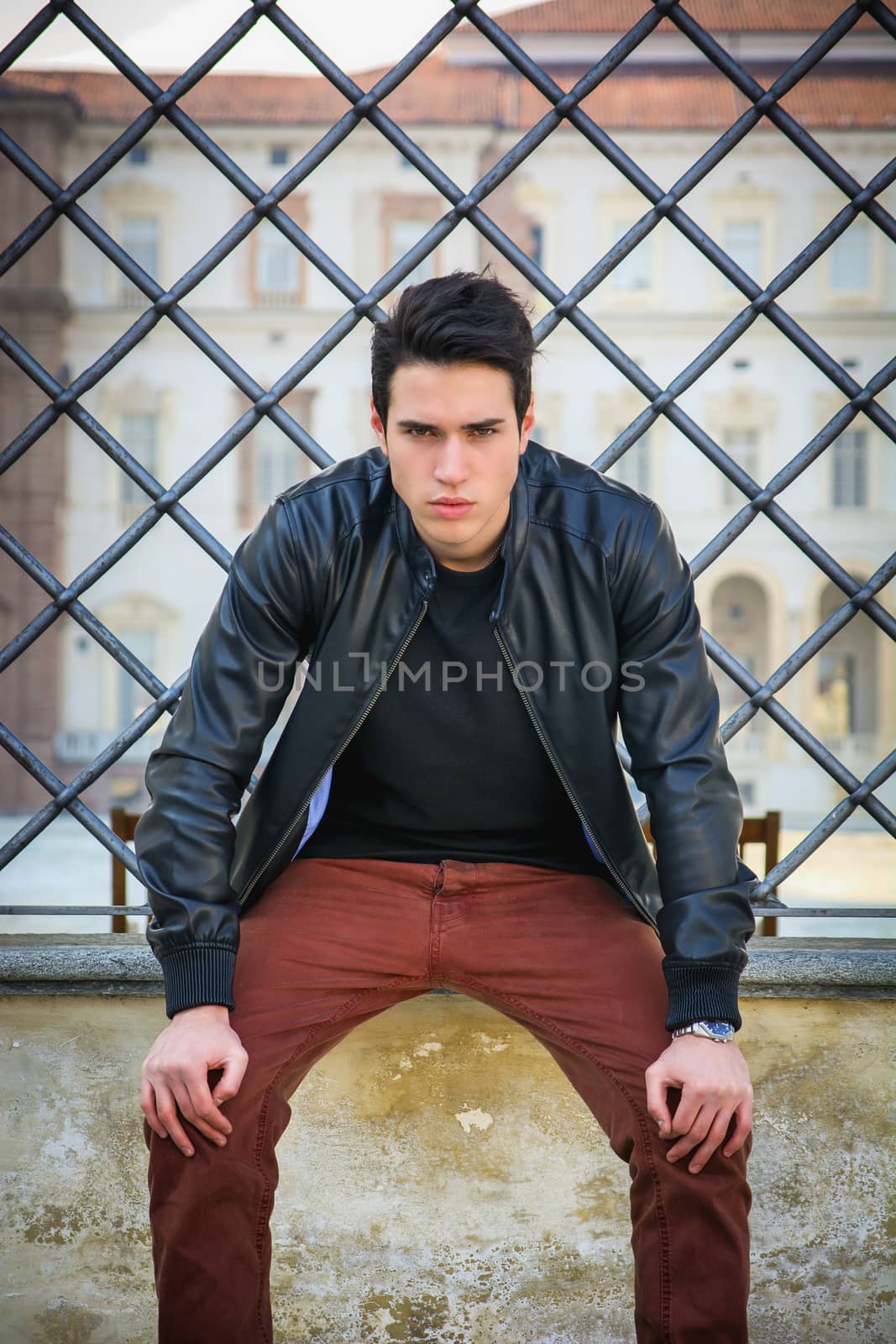 Handsome young man outside historical building in European city by artofphoto