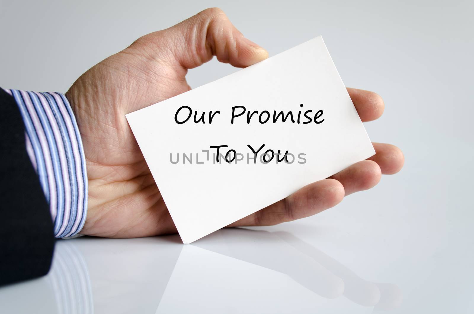 Bussines man hand with text Our promise to you