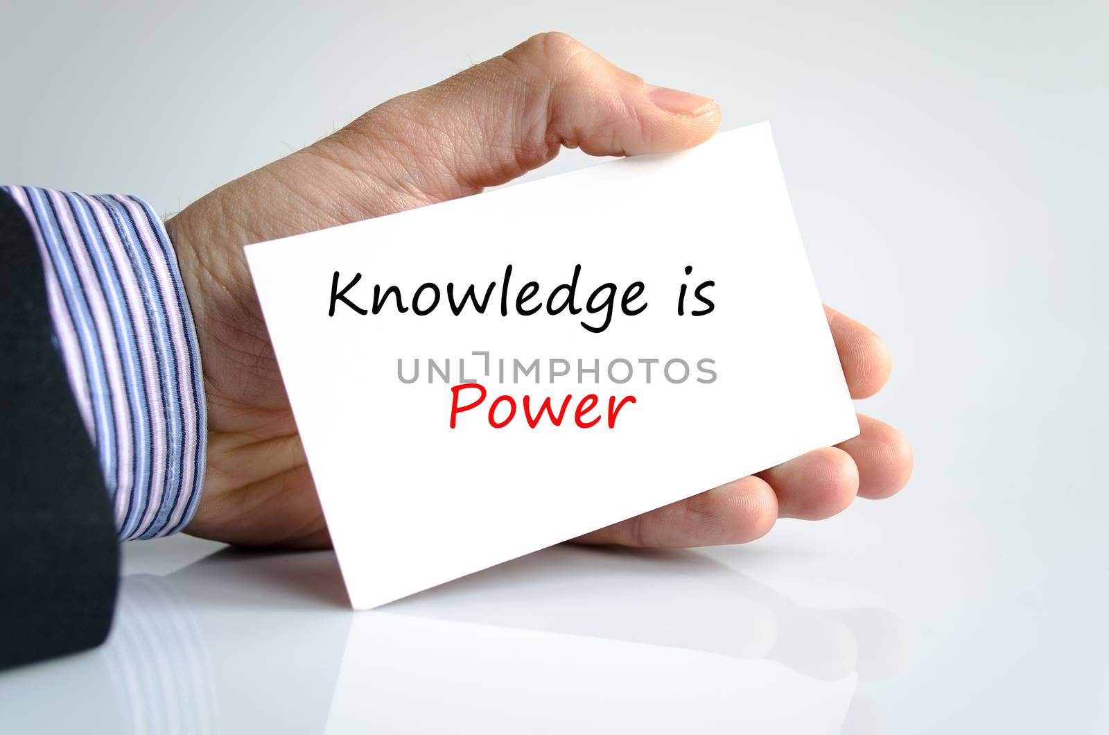 Knowledge is power note in bussines man hand