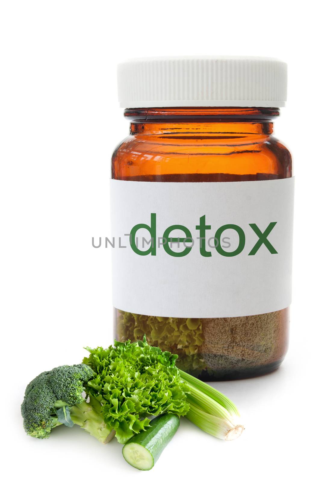 Medicine jar with detox vegetables over a white background